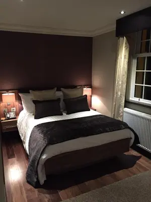 a bedroom with a large bed with two pillows at Busby Hotel in Busby