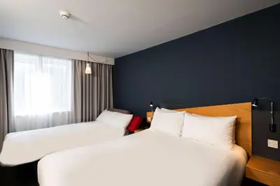 a hotel room with two beds and a window at Holiday Inn Express Stirling by IHG in Stirling