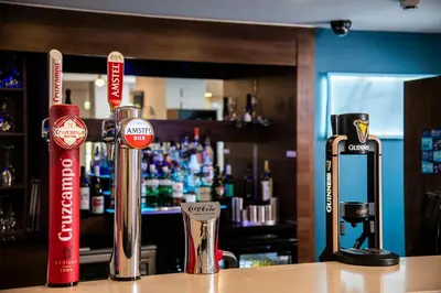 a bar with two bottles of alcohol on a counter at Holiday Inn Express Stirling by IHG in Stirling