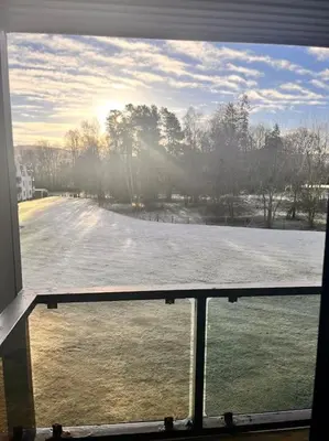 a view of a snow covered street from a window at Gleneagles Apartment in Auchterarder