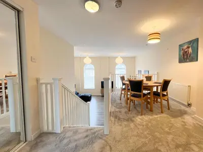 a dining room with a table and chairs at Duplex Apartment in Glasgow in Glasgow