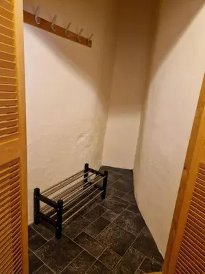 a hallway with a bench in a room at The Old Post Office House in Perth