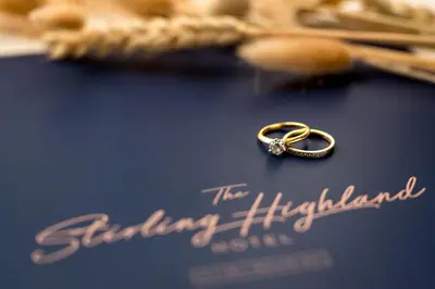 a gold engagement ring sitting on top of a blue card at Stirling Highland Hotel- Part of the Cairn Collection in Stirling