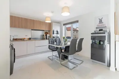 a kitchen with a dining room table and chairs at Scenic getaway, open plan home! 2bed park for free in Eaglesham