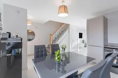 a kitchen and dining room with a table and chairs at Scenic getaway, open plan home! 2bed park for free in Eaglesham