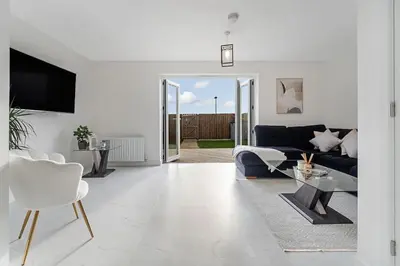 a living room with a blue couch and a table at Scenic getaway, open plan home! 2bed park for free in Eaglesham