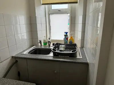 a kitchen counter with a sink and a window at 140 MAIN ST GROUND LEFT in Largs