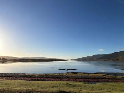 a large body of water with mountains in the background at Argyll House Pennyghael in Salen
