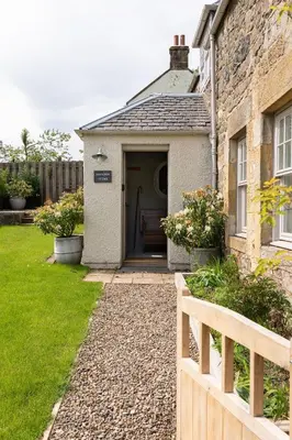 a small house with a gate and a fence at Shepherds Cottage, Pentland Hills in Nine Mile Burn