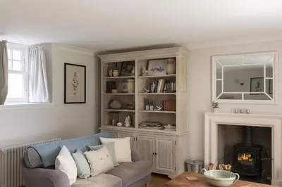 a living room with a couch and a fireplace at Shepherds Cottage, Pentland Hills in Nine Mile Burn