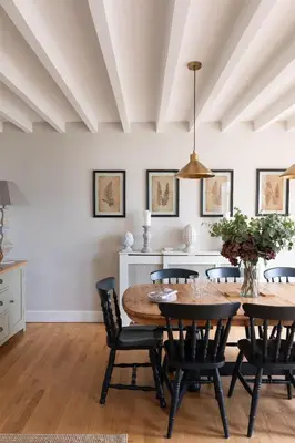a kitchen and dining room with a table and chairs at The Coach House, Pentland Hills in Nine Mile Burn