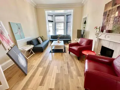 a living room with couches and a fireplace at Dumbarton cosy home, Loch Lomond in Dumbarton