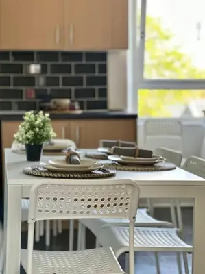 a white table and chairs in a kitchen at Dumbarton cosy home, Loch Lomond in Dumbarton