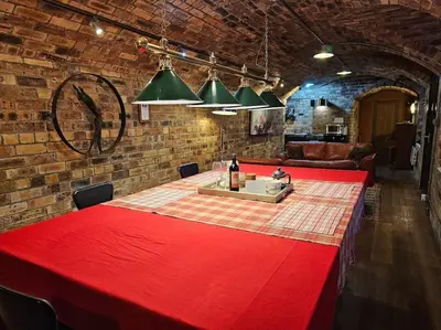 a red table in a room with a brick wall at The Armoury: Stylish WW1 Bunker in North Queensferry