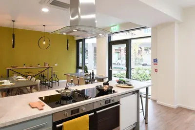 a kitchen with a stove top oven next to a dining room at For Students Only St Mungo's in Glasgow in Glasgow