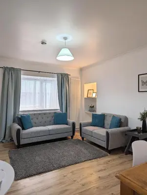 a living room with two couches and a window at Erradale in Campbeltown