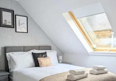 a bedroom with a bed and a window at Erradale in Campbeltown