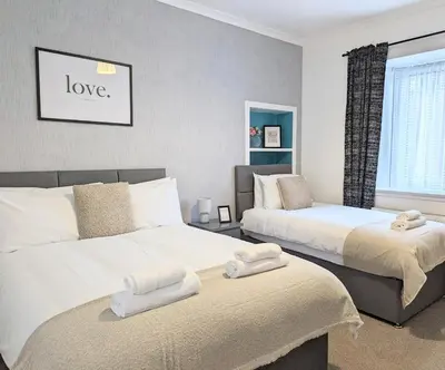 a bedroom with two beds with towels on them at Erradale in Campbeltown