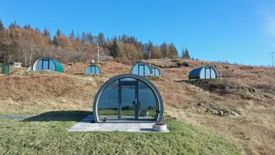 a dome house with a window on a hill at Port Nan Gael Pods in Pennyghael