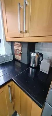 a kitchen counter with a toaster on top of it at Stylish home in Linlithgow Near Edinburgh Airport Free parking Free WiFi in Linlithgow