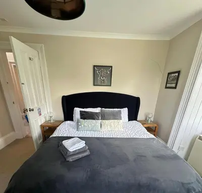a bedroom with a large bed with two pillows at Room 1, Loch Etive House, Connel near Oban in Connel