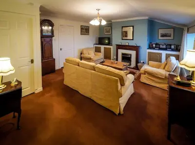 a large living room with couches and a fireplace at Pirnmill Home with a view in Pirnmill