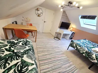 a room with a table and a bed and a desk at Mini hotel with home facilities in Hamilton West in High Blantyre