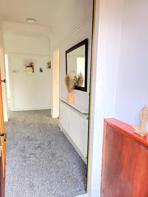 a hallway with a mirror on a wall at Charming 3-Bed Oasis-free parking in Glasgow