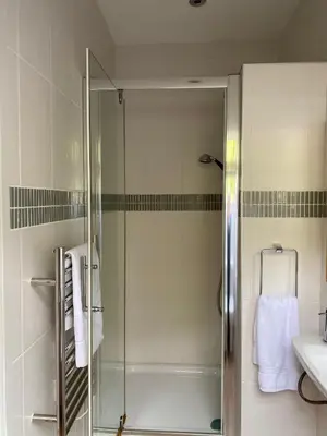 a shower with a glass door in a bathroom at Tigh na Breac - Great Outdoor Activity Location Oban in Bonawe