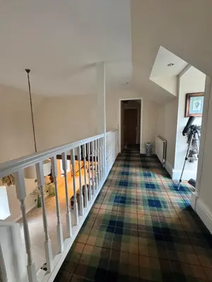 a hallway with a staircase with a colorful floor at WestLaigh Lrg Luxury Country Farm House 20 min from the city in Glassford