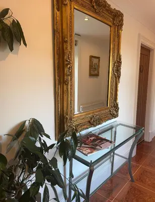 a mirror and a glass table and a plant at WestLaigh Lrg Luxury Country Farm House 20 min from the city in Glassford