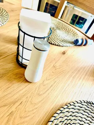 a black and white thermos on a wooden table at Gleddoch Coach House in Langbank