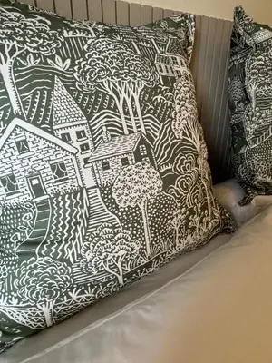 a pillow sitting on top of a bed at Island View - Spacious Two Bedroom Oban Apartment with Sea Views in Oban