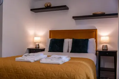 a bedroom with a bed with towels on it at Jura Apartment in Oban