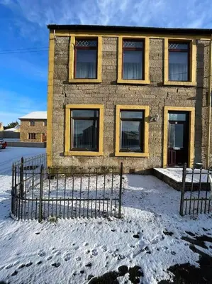 a brick building with snow in front of it at M Rooms 97a at the Brandy Bar in Kirk of Shotts