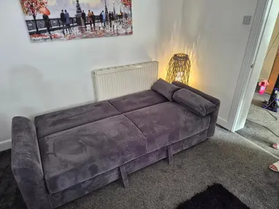 a brown couch in a living room with a lamp at M Rooms 97a at the Brandy Bar in Kirk of Shotts