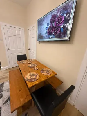 a dining room table with a painting on the wall at One Bedroom Flat in Central Edinburgh Old Town , Heart of Edinburgh Flat Sleeps 4 in Edinburgh
