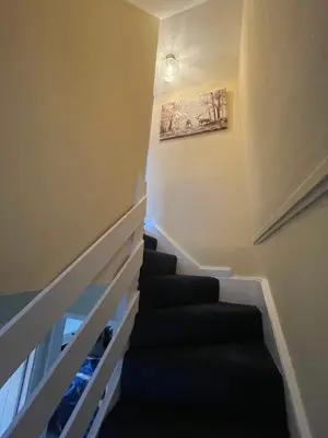 a staircase in a house with a painting on the wall at Gateway to the Loch in Balloch