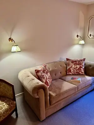 a living room with a brown couch and two lamps at 1 The Cairn Kilmartin - Beautiful Victorian Flat, Pet Friendly in Kilmartin