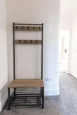 a bench sitting in the corner of a room at Helensburgh Holiday Apartment in Helensburgh