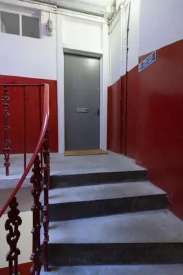 a hallway with stairs and a door in a building at Helensburgh Holiday Apartment in Helensburgh