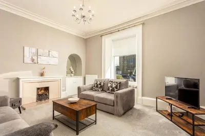 a living room with a couch and a tv at South Beach View in Troon