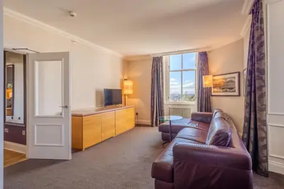 a living room with a couch and a television at Apex Dunblane Hydro in Dunblane