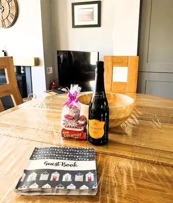 a bottle of wine sitting on top of a table at Clarinnes Cottage in Luss