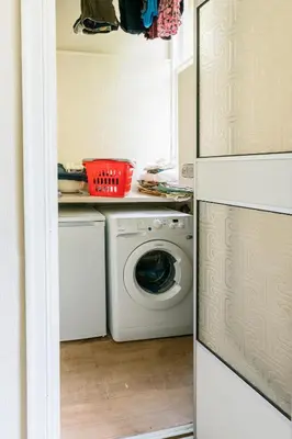 a laundry room with a washer and dryer at Palm Tree Apartment- Period Home with Cat in Edinburgh