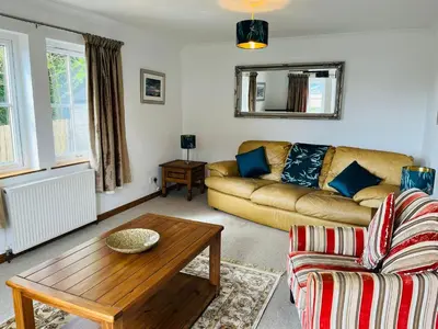 a living room with a couch and a table at Avoca House in Fort William