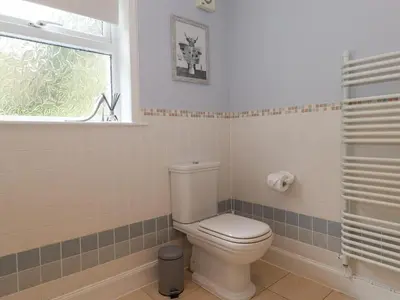 a bathroom with a white toilet and a window at Glen View in Dumfries