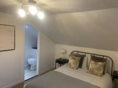a bedroom with a bed with two pillows at Sleeps7-Parking-Garden-Patio in Johnstone