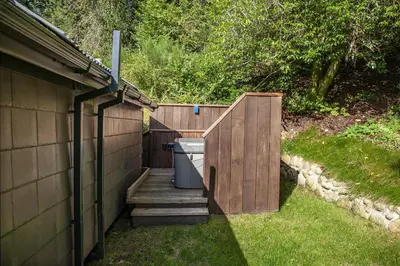 a small backyard with a wooden fence and a house at Dundonald Landing Palms 2 in Oban