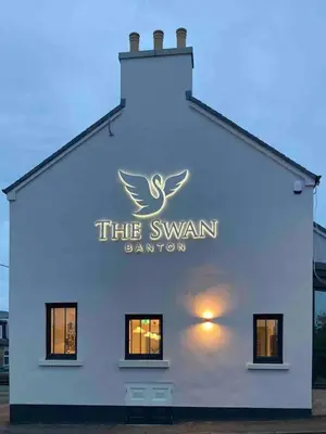 a white building with a sign for the swarm damion at Keppochhill - Beautiful Home with Hot Tub in Banton